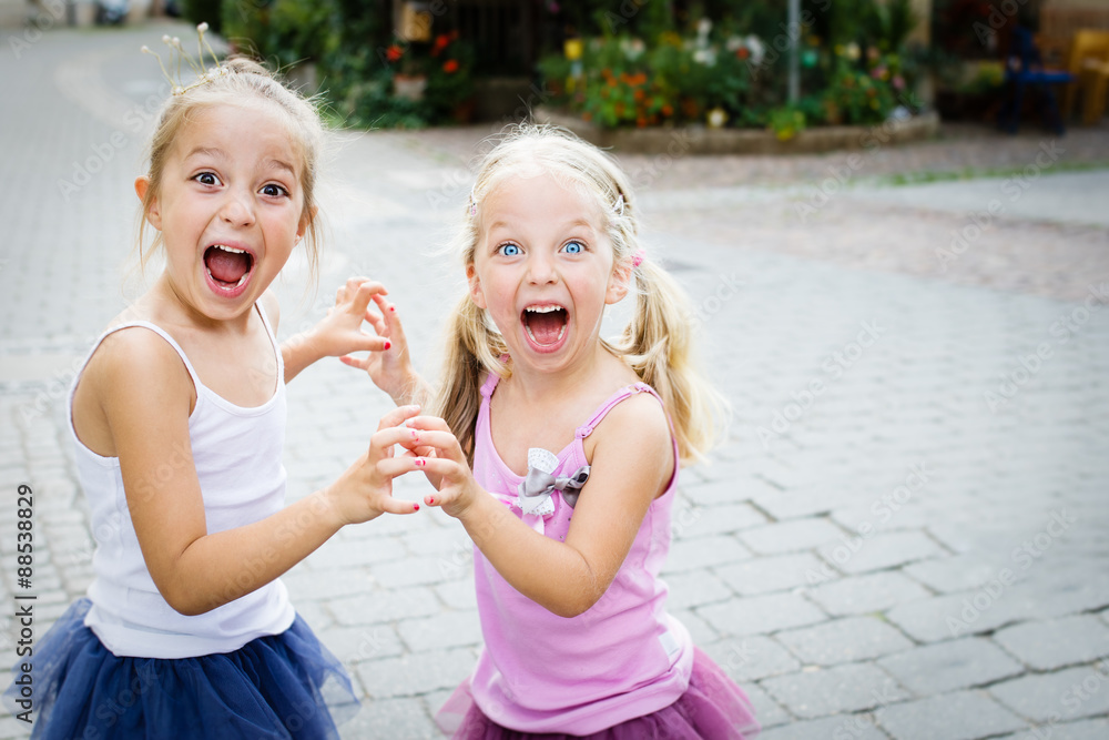 two liitle sisters shouting on the street two liitle sisters shouting on the street
