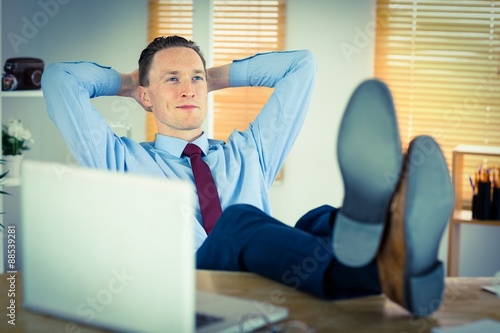 Relaxed businessman with his feet up