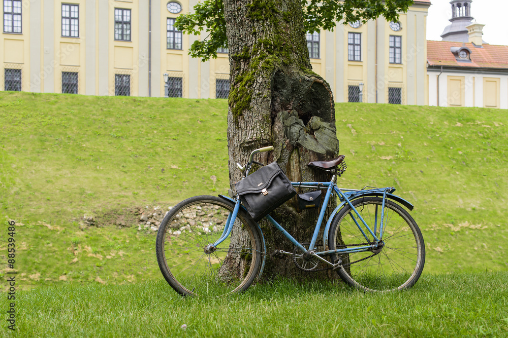 Old bicycle near the medieval castle. Nesvizh, Belarus. Focus on