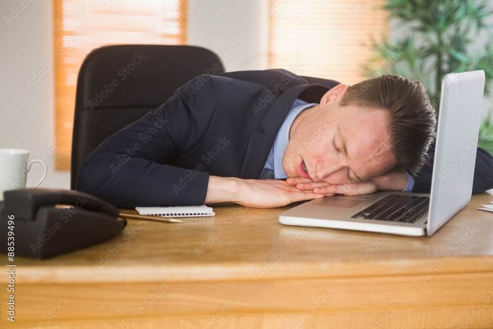 Exhausted businessman sleeping on his laptop Exhausted businessman sleeping on his laptop