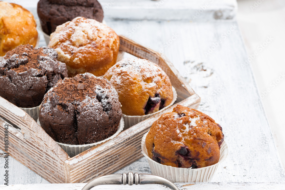 delicious muffins on a wooden tray on white background delicious muffins on a wooden tray on white background