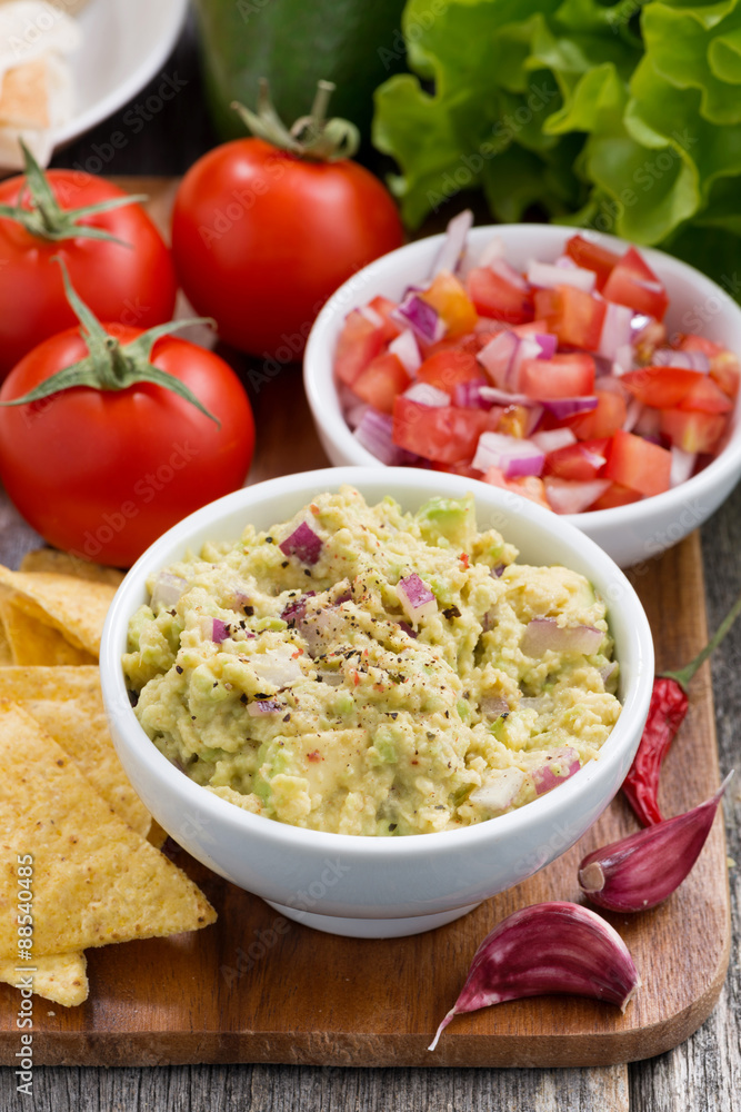 guacamole, tomato salsa and corn chips, vertical guacamole, tomato salsa and corn chips, vertical