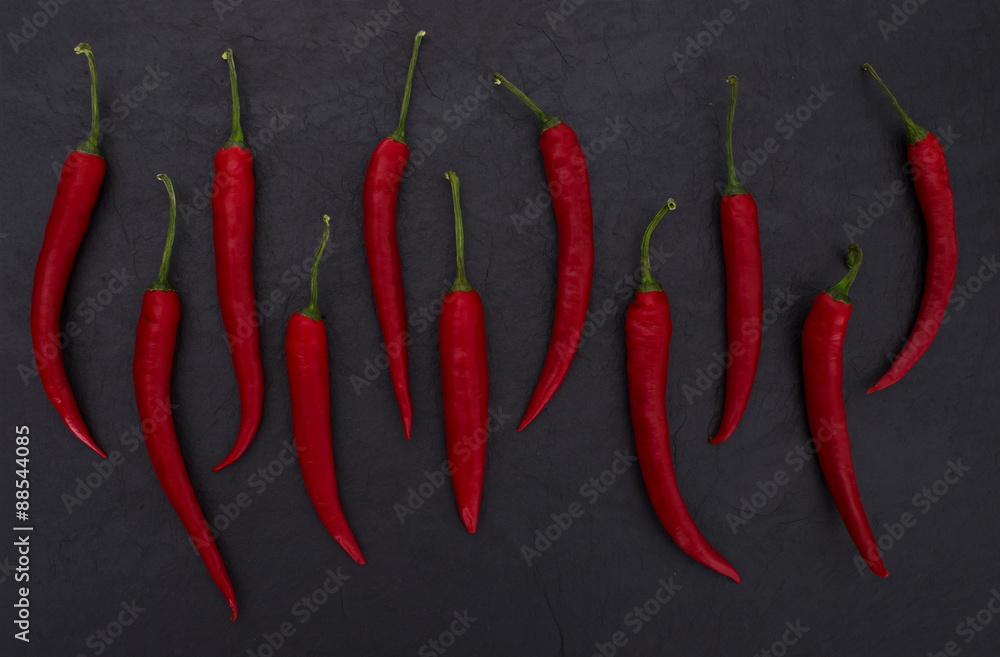 red peppers on black slate background 