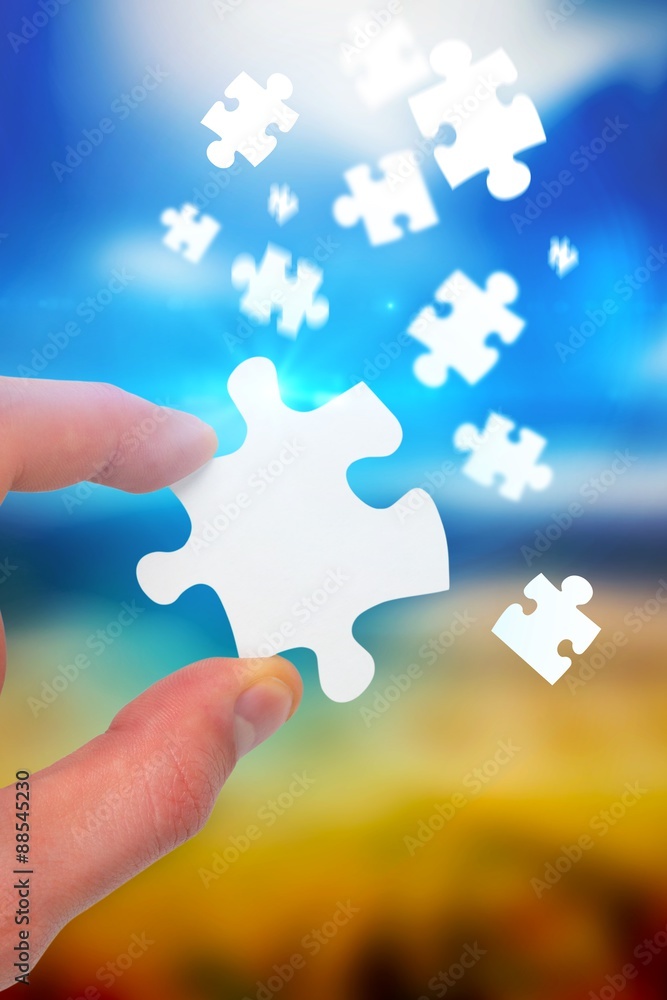 Composite image of hand holding jigsaw piece Composite image of hand holding jigsaw piece