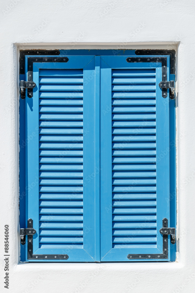 Fototapeta premium Blue window with Bahama shutters