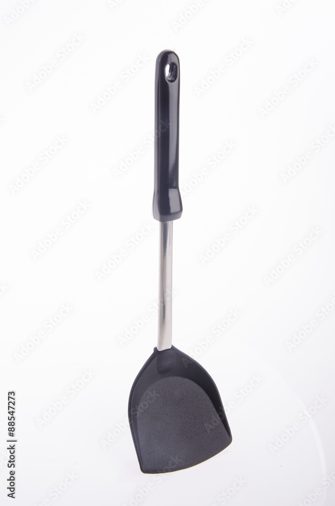Black plastic kitchen spatula on background. Black plastic kitchen spatula on background.
