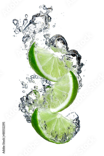 Lime slices falling into water