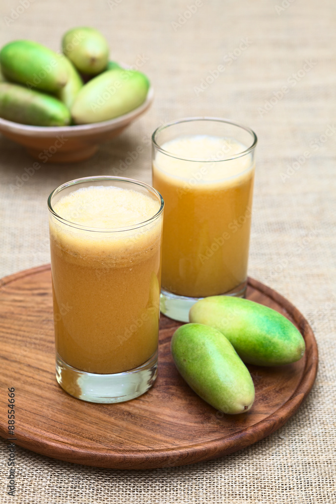 Fresh juice made of the Latin American fruit called banana passionfruit (lat. Passiflora tripartita) (in Spanish mostly tumbo, curuba, taxo) (Selective Focus, Focus on the front of the first glass) Fresh juice made of the Latin American fruit called banana passionfruit (lat. Passiflora tripartita) (in Spanish mostly tumbo, curuba, taxo) (Selective Focus, Focus on the front of the first glass)