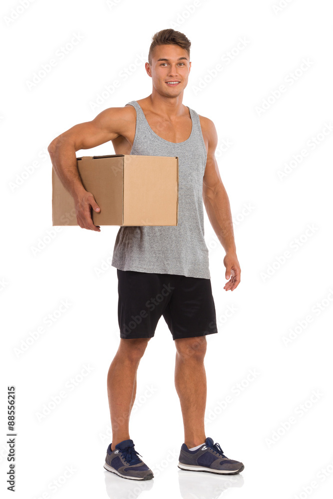 Sportsman Holds Delivery For You. Full length studio shot isolated on white.
