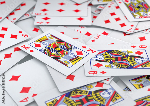 Pile of cards diamonds suite lying on table