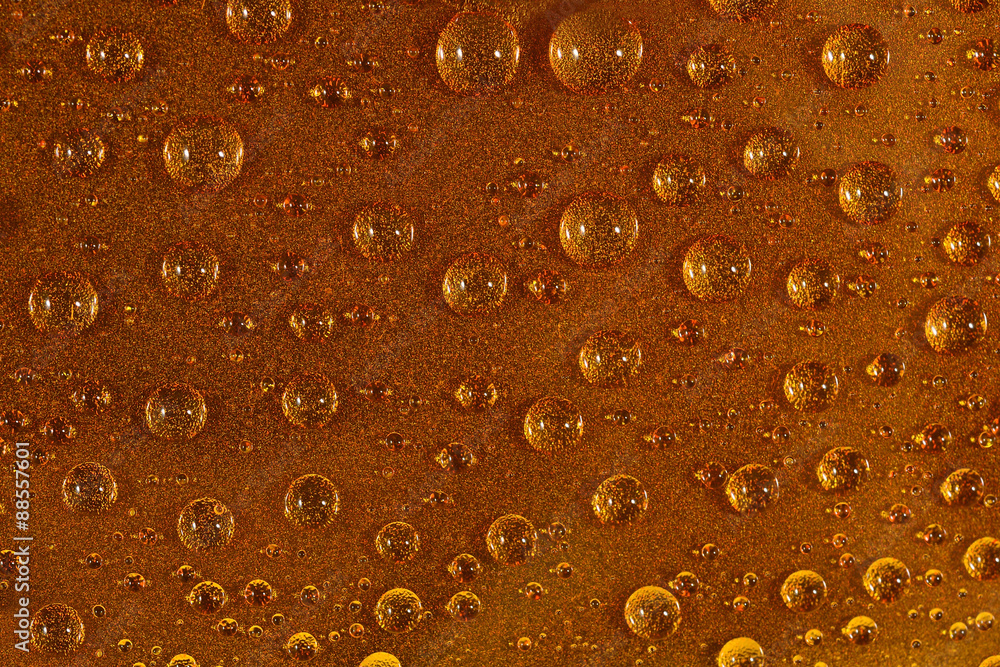 Water drops on the brown surface Water drops on the brown surface