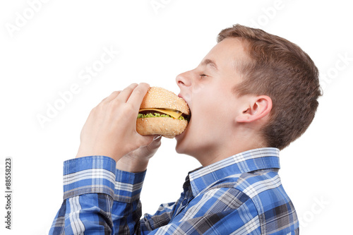 Little boy eating a burger....