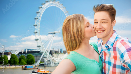 Sticker happy couple taking selfie over london