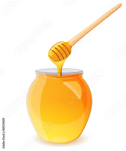 A jar of honey and spoon for honey