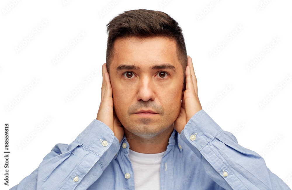 face of man covering his ears with hands face of man covering his ears with hands