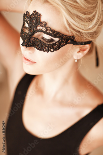 Portrait of sensual woman with luxurious blond hair with mask on