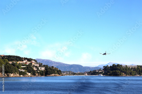 Sea view. Mountain view. Town view. Beautiful Ionian dark blue sea. Sky and sea. Beauty in nature. Corfu. Kerkyra. Greece island. The plane coming in to land