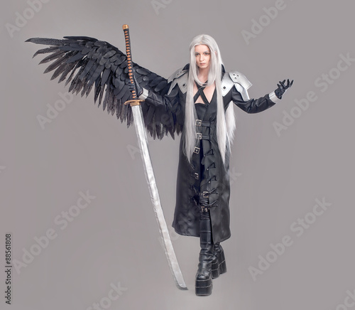 Fantasy woman warrior / Woman warrior with sword and wings isolated on the gray background photo