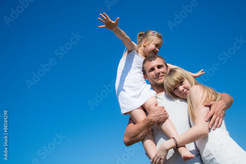 Happy father with his little daughter and wife