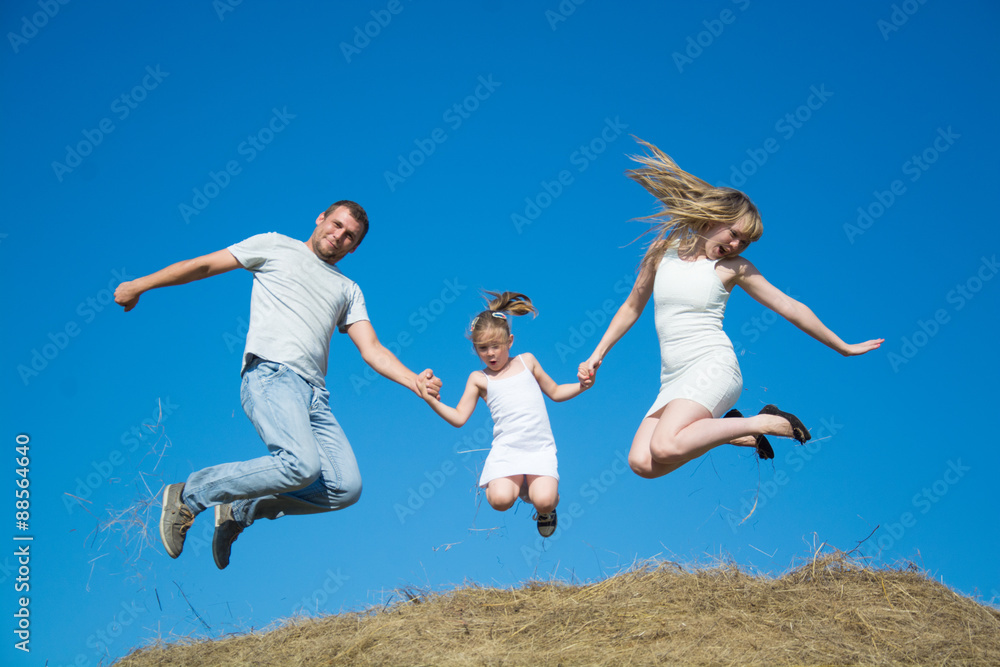 young family dad mom daughter jumping on haystack young family dad mom daughter jumping on haystack