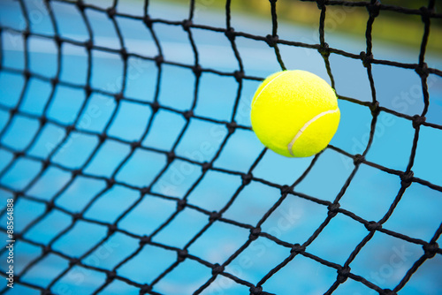 tennis ball on a tennis court with net