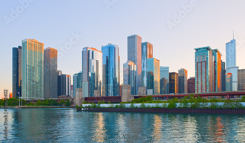 Chicago Illinois skyline at sunset with illuminated downtown buildings