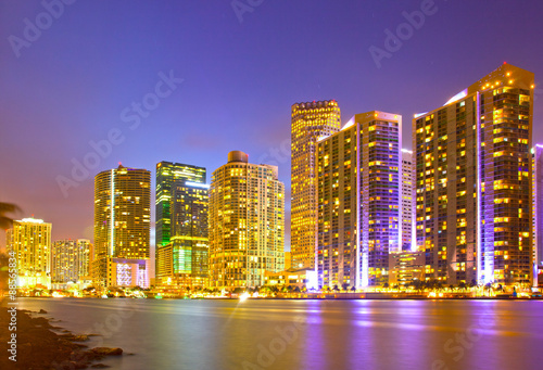 City of Miami Florida, night skyline. Cityscape of residential and business buildings illuminated at sunset with reflection © FotoMak