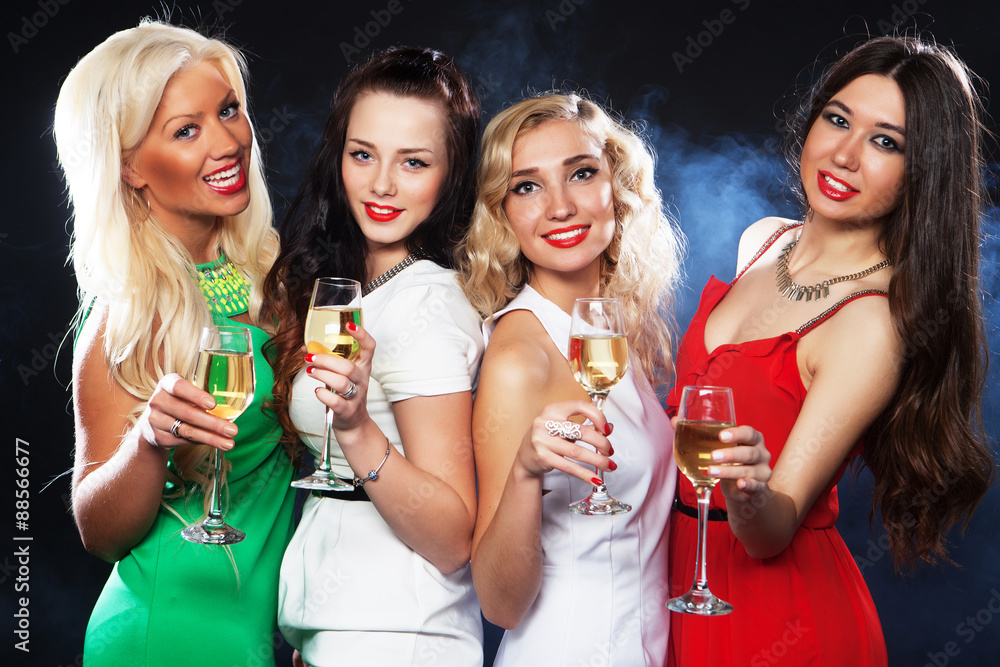 girls clinking flutes with sparkling wine girls clinking flutes with sparkling wine