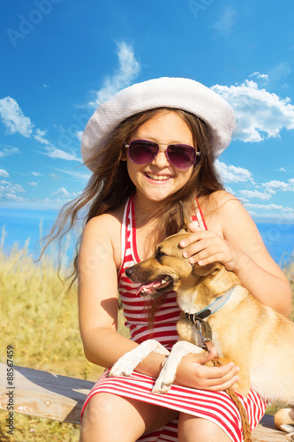 child gently embracing a dog photo