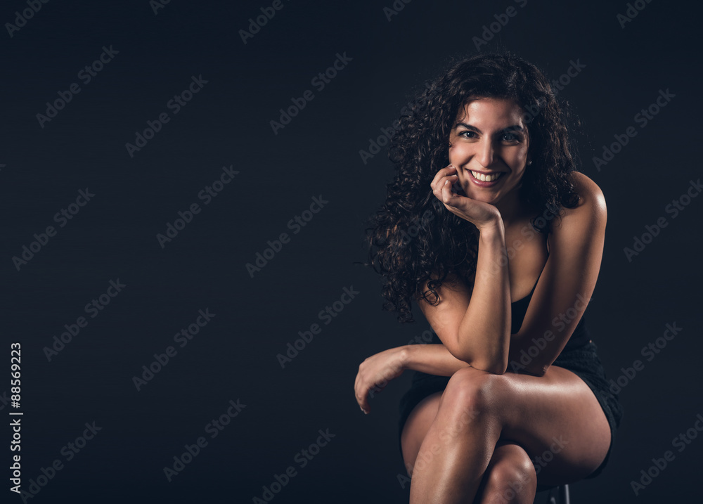 Beautiful brunette posing on a black background Beautiful brunette posing on a black background