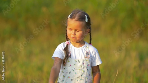 The small girl hold and launch paper airplane not successfully. Slow motion photo