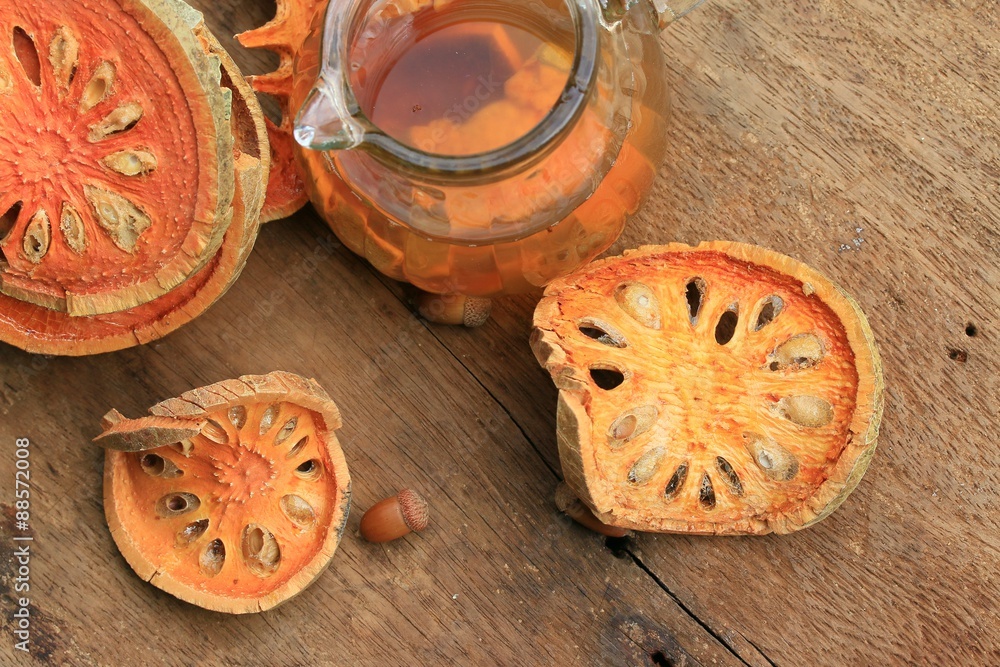 Slices of dried bael fruit and juice Slices of dried bael fruit and juice