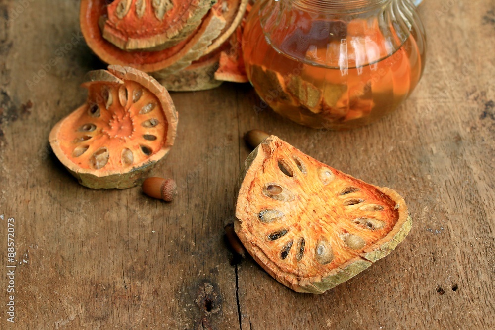 Slices of dried bael fruit and juice Slices of dried bael fruit and juice