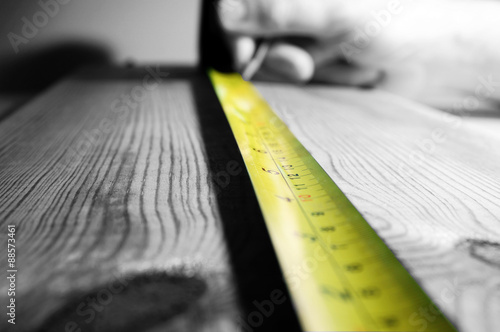 Tape measure wood.
Abstract image of a tape measure on a piece of wood. photo