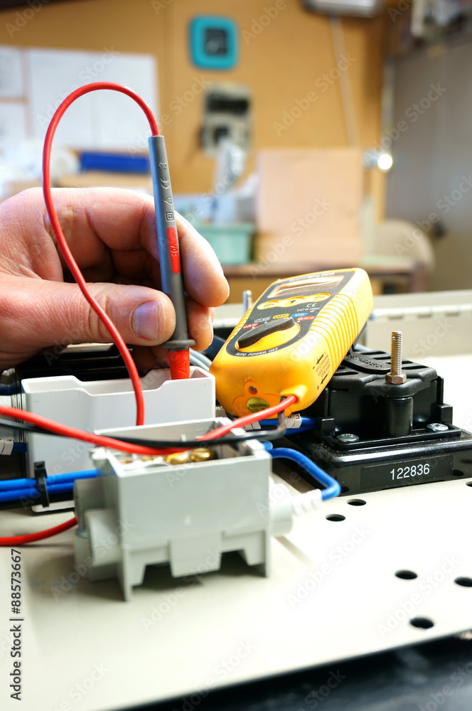 Testing wiring circuit.
Man at work testing wiring with a multi meter. Testing wiring circuit.
Man at work testing wiring with a multi meter.