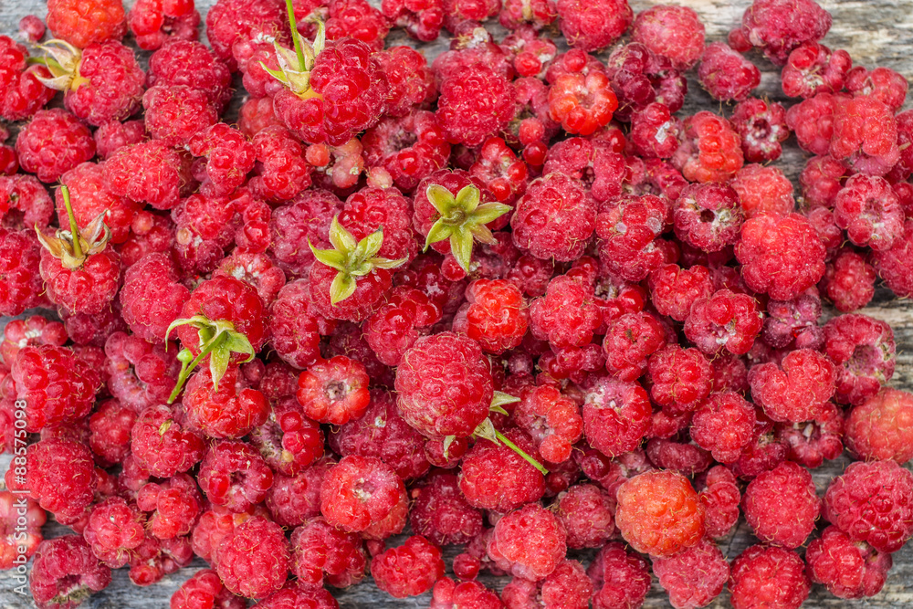 Delicious fresh raspberries scattered on the table Delicious fresh raspberries scattered on the table