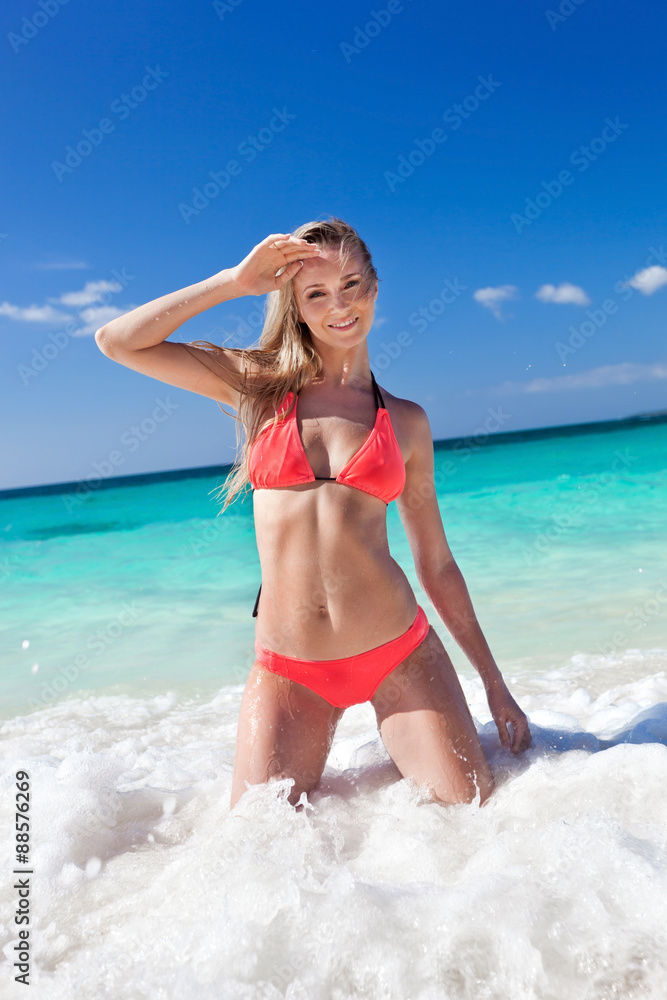 happy woman in bright bikini on beach