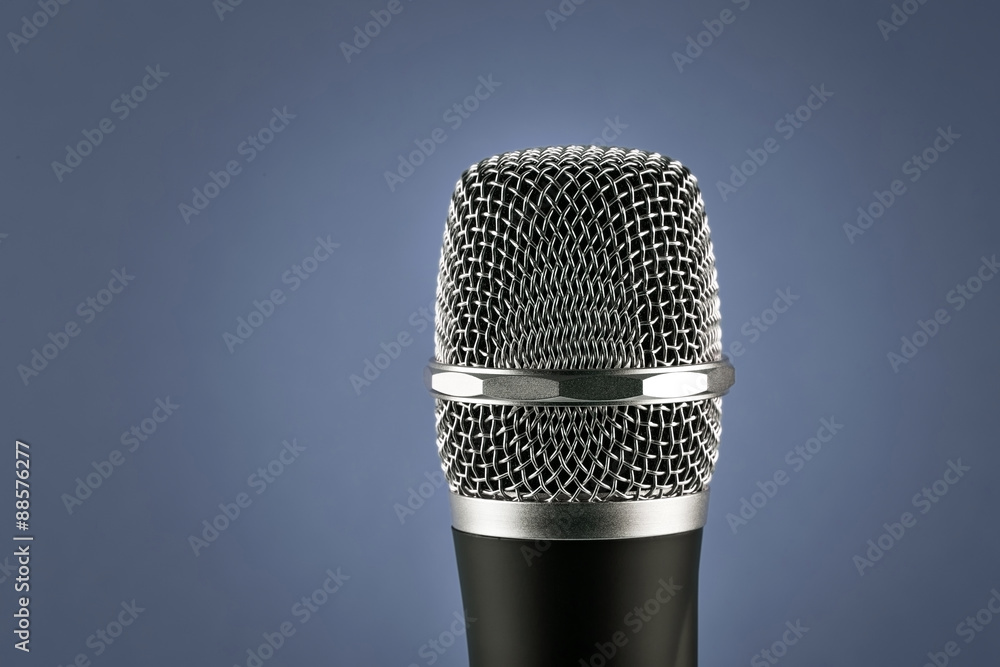 Wireless microphone on blue background Wireless microphone on blue background