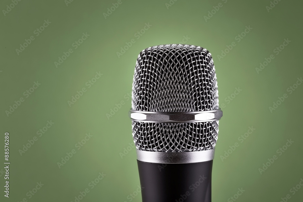 Wireless microphone on green background Wireless microphone on green background