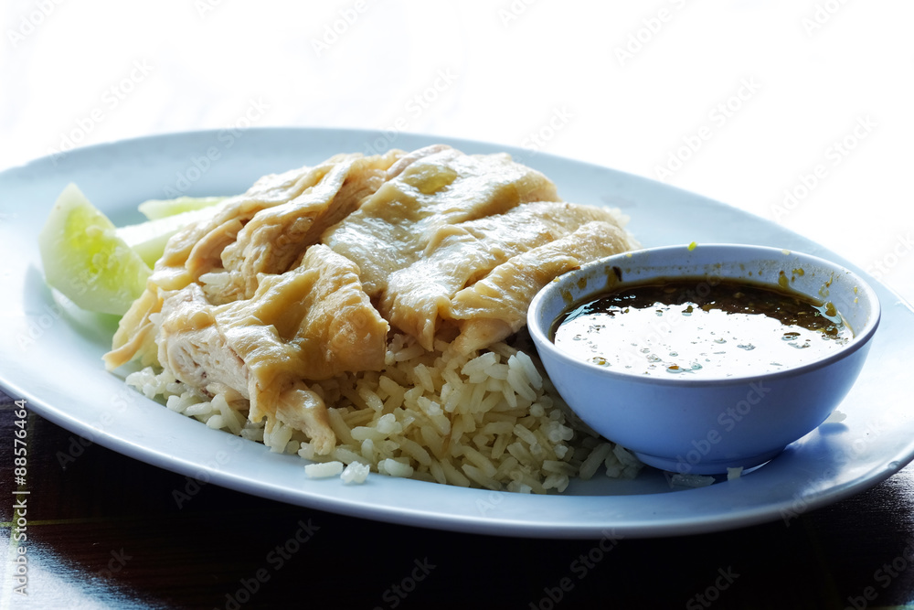 hainanese boiled chicken rice on the wooden table hainanese boiled chicken rice on the wooden table