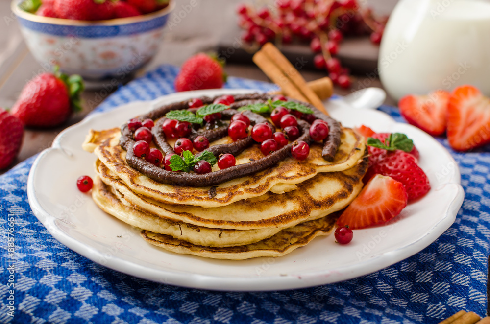 Cinnamon pancakes with chocolate sauce and berries Cinnamon pancakes with chocolate sauce and berries