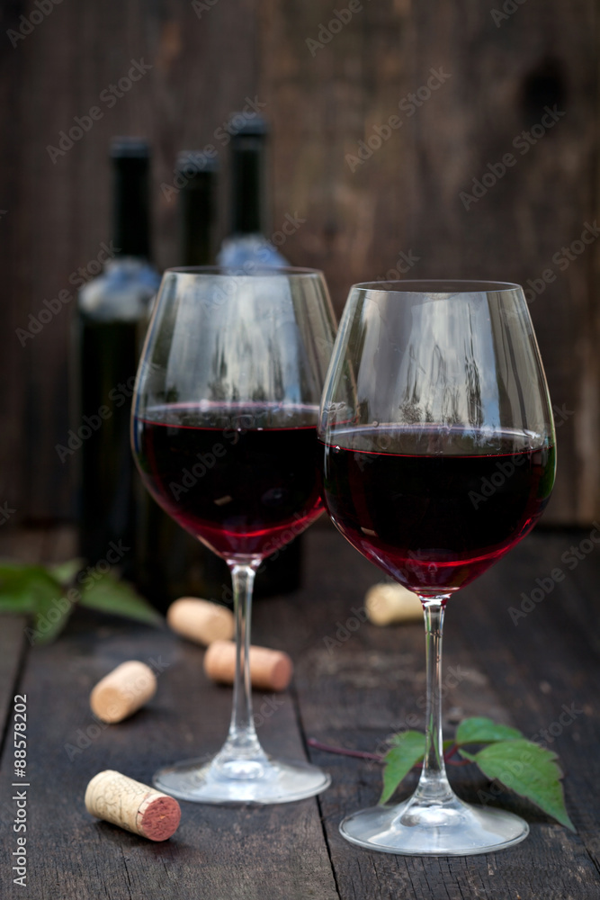 Glass of red wine on old wooden table