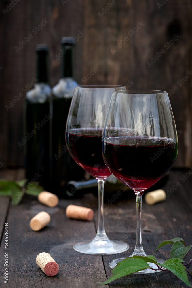 Glass of red wine on old wooden table Glass of red wine on old wooden table