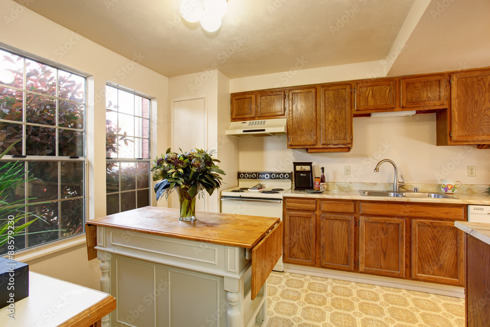 Traditional kitchen with tile floor, and small island. Traditional kitchen with tile floor, and small island.