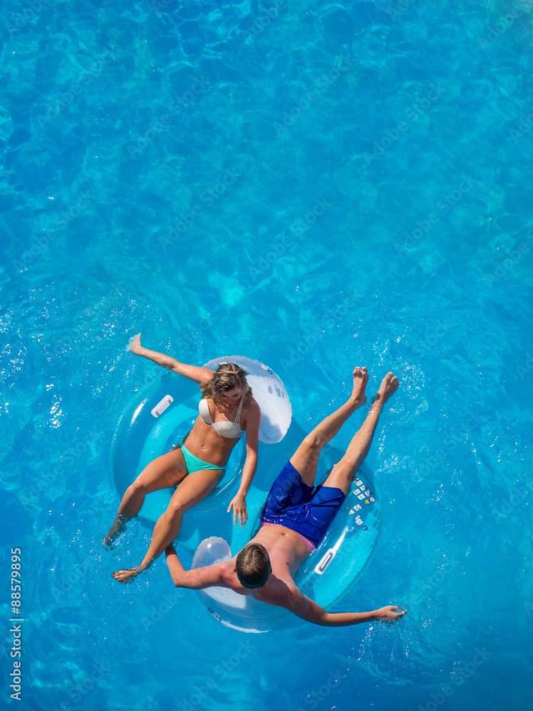 Couple Outside Relaxing In Swimming Pool