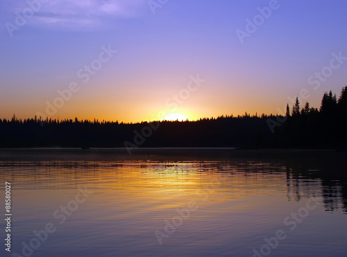 Sunrise over the lake and forest