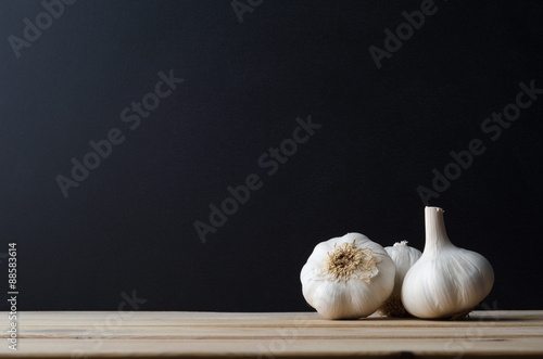 Garlic Bulbs Arranged on Wood with Black Background