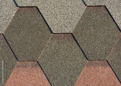 Different color shingles or bitumen tile background. Abrasive texture roofing material.