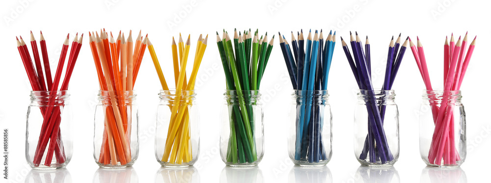 Bright pencils in glass jars, isolated on white Bright pencils in glass jars, isolated on white