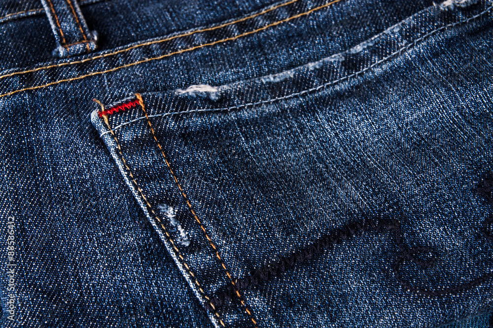 fashionable clothes. pile of jeans on a wooden background fashionable clothes. pile of jeans on a wooden background